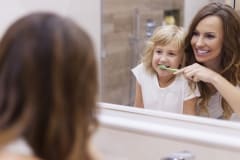 Morning lesson of brushing teeth with mommy